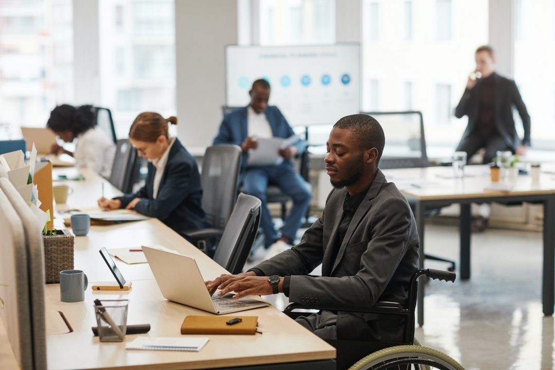 businessman using wheelchair in office